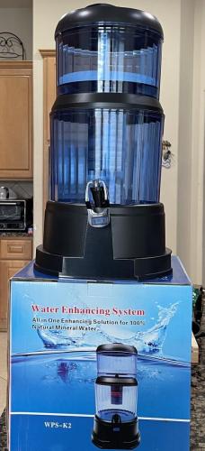 Water filter base with lower reservoir and spout